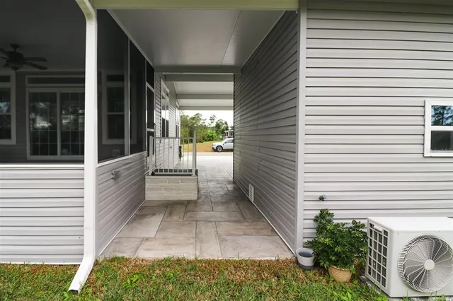 a view of a porch with a table and chairs