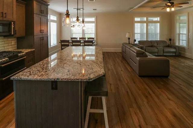 a kitchen with counter top space and wooden floor