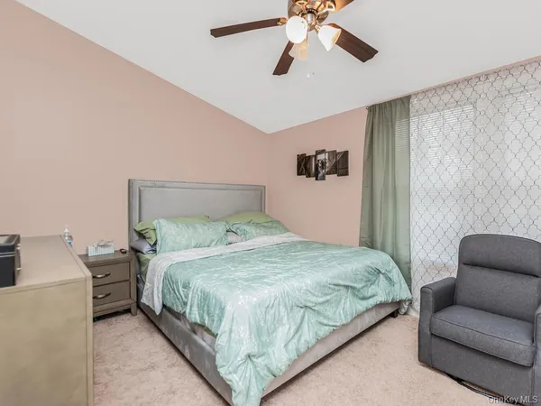 a bedroom with a bed couch and window