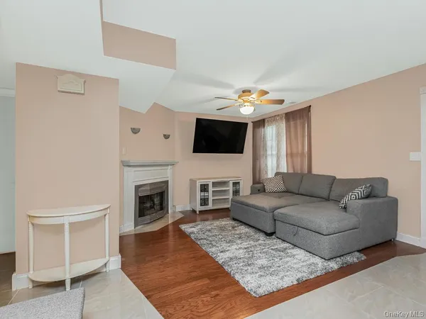 a living room with furniture a fireplace and a flat screen tv