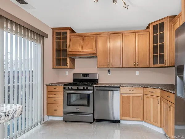 a kitchen with stainless steel appliances granite countertop a stove and a sink