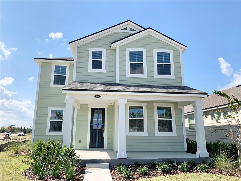323 Sweetgum Street Yulee, FL 32097 - Photo 1 of 1 a front view of a house with a yard