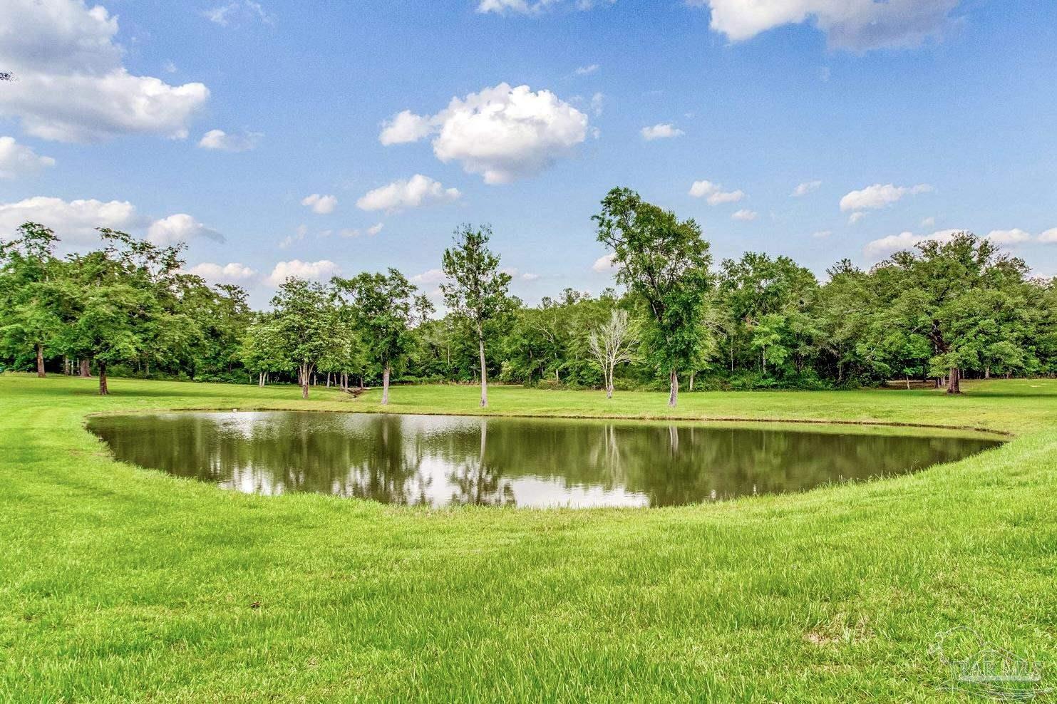 4664 Kolb Road Milton, FL 32570 - Photo 1 of 20 a view of a golf course with a lake view