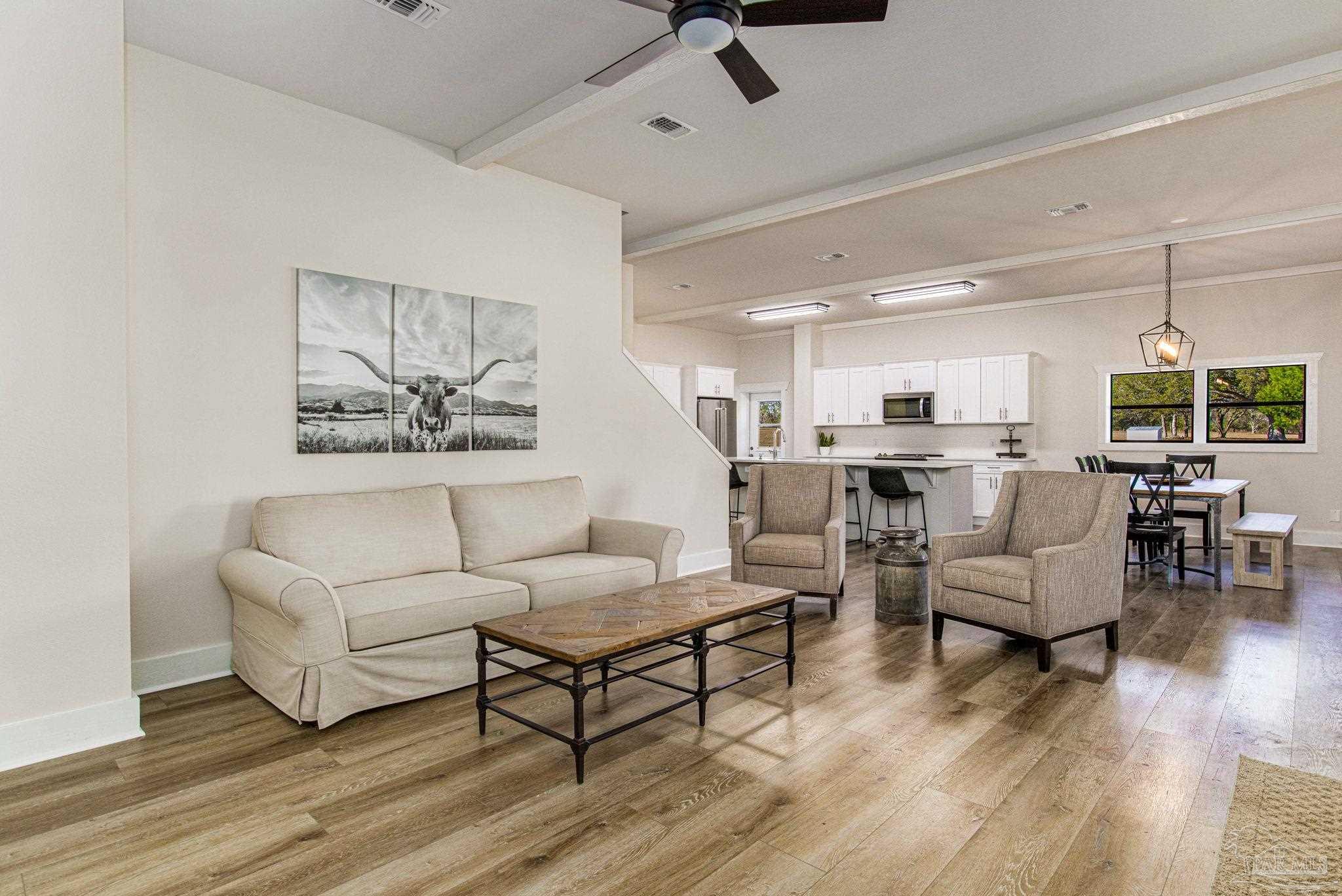 4664 Kolb Road Milton, FL 32570 - Photo 12 of 20 a living room with furniture kitchen view and a wooden floor