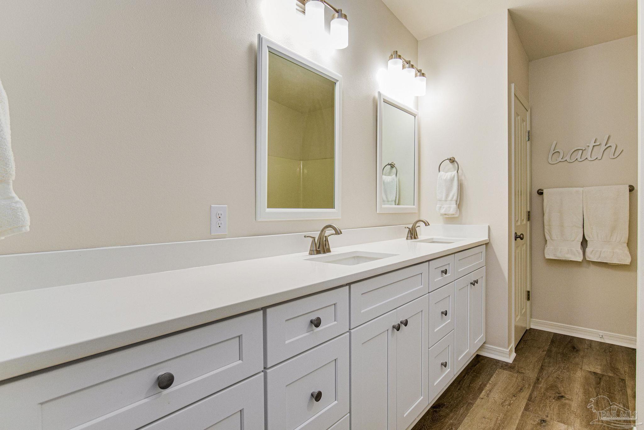 4664 Kolb Road Milton, FL 32570 - Photo 17 of 20 a bathroom with a sink and a mirror