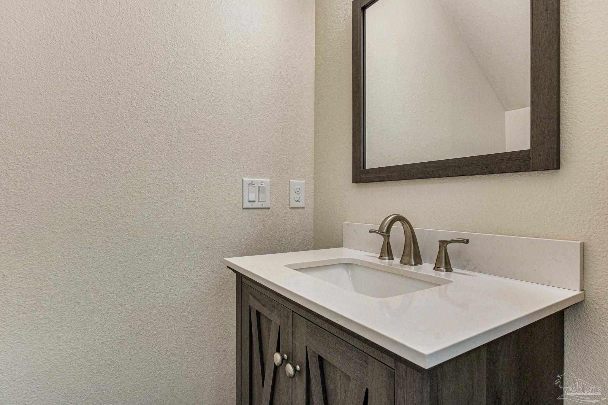 4664 Kolb Road Milton, FL 32570 - Photo 18 of 20 a bathroom with a sink and a mirror