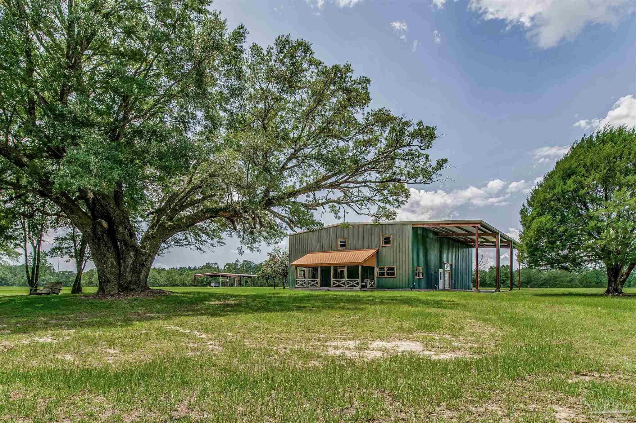 4664 Kolb Road Milton, FL 32570 - Photo 3 of 20 a front view of house with yard and green space
