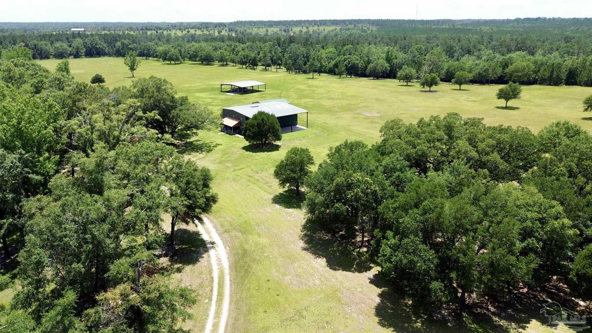 4664 Kolb Road Milton, FL 32570 - Photo 4 of 20 a view of a lake with a yard