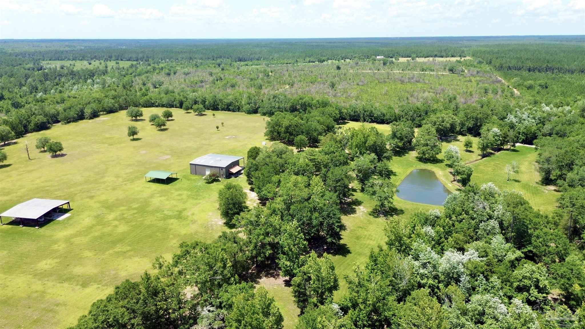 4664 Kolb Road Milton, FL 32570 - Photo 5 of 20 a view of a lake with a yard