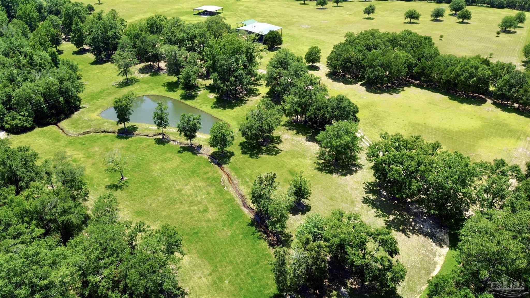 4664 Kolb Road Milton, FL 32570 - Photo 6 of 20 an aerial view of residential houses with outdoor space and trees all around