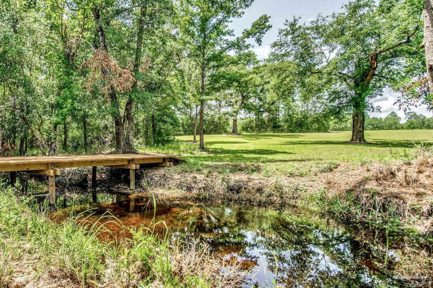 4664 Kolb Road Milton, FL 32570 - Photo 9 of 20 a view of backyard with deck and trees