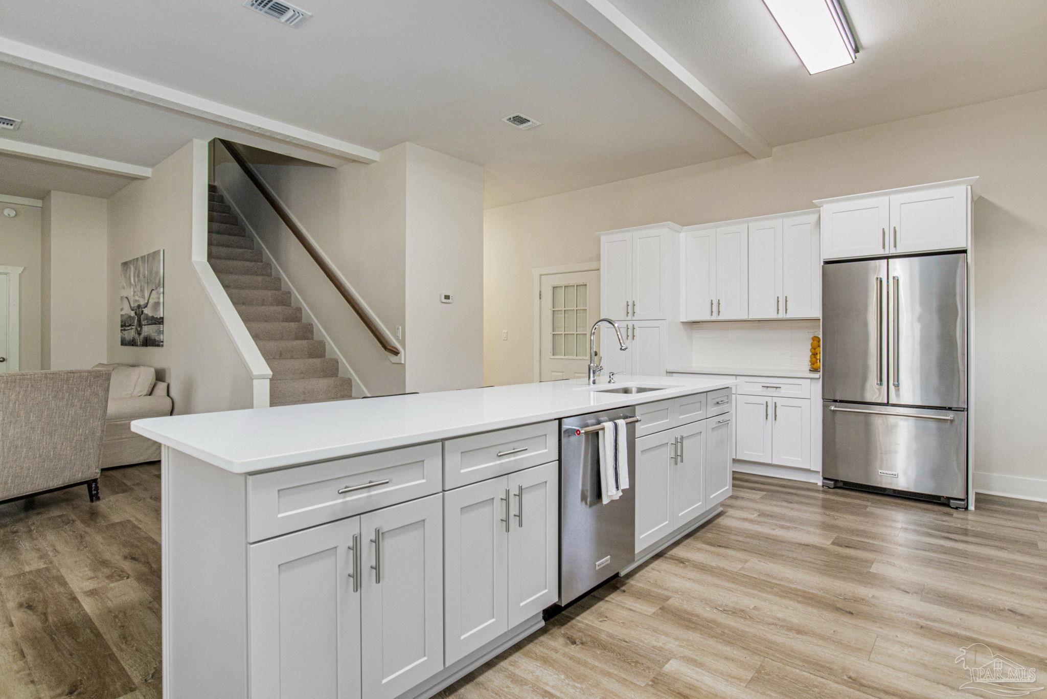 4664 Kolb Road Milton, FL 32570 - Photo 10 of 20 a kitchen with white cabinets and white appliances