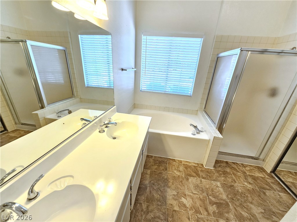 2817 Albemarle Way Henderson, NV 89014 - Photo 19 of 25 Dual vanities and a deep soaking tub complete this well-appointed primary bathroom.