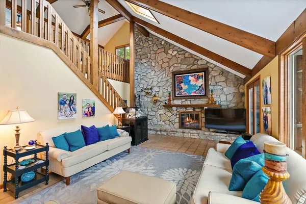 a bedroom with a large bed and a chandelier