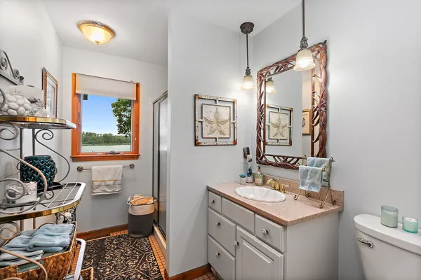 a spacious bedroom with a bed dresser and a flat tv screen