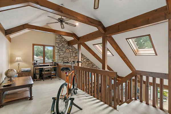 a view of a big room with dining area a flat screen tv and a fireplace