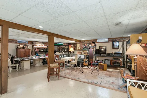 a view of a storage room with a refrigerator and a table
