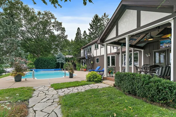 a view of a house with a yard and sitting area