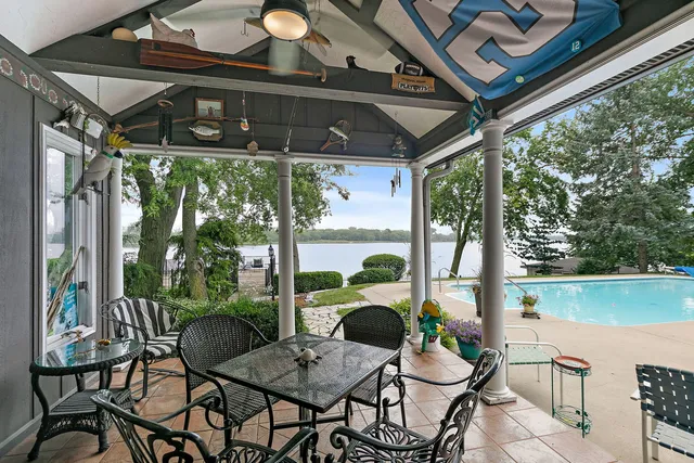 swimming pool view with a seating space