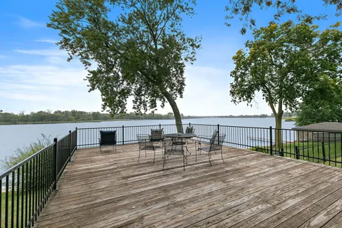 an aerial view of house with yard and lake view