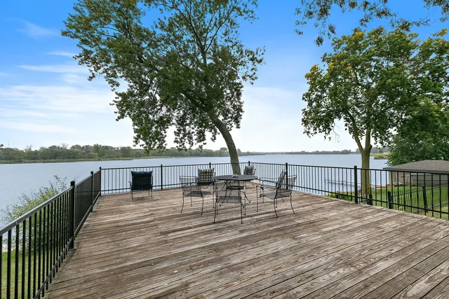 an aerial view of house with yard and lake view