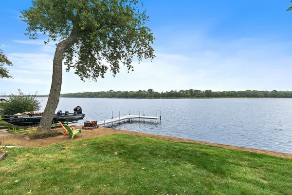 an aerial view of a house with a garden and lake view