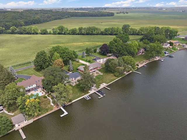 a swimming pool with outdoor seating and yard