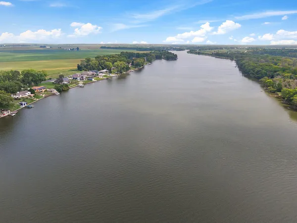 a view of a lake with a house and a yard with a lake view