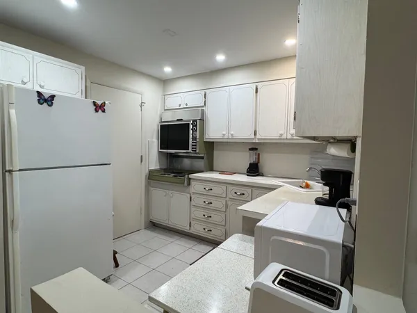 a kitchen with a refrigerator stove and microwave