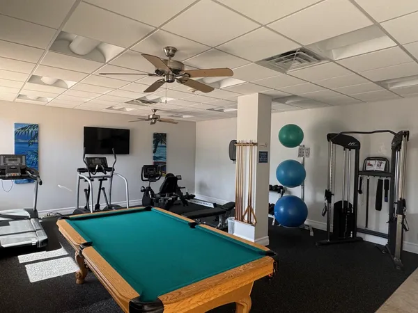 a room with gym equipment and large window