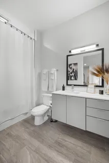 a bathroom with a sink mirror vanity and toilet