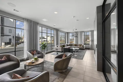 a living room with furniture and large windows