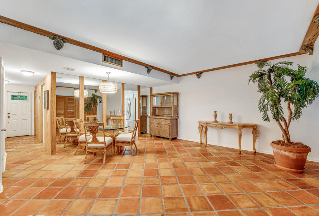6590 North Ocean Boulevard, Unit 3 Ocean Ridge, FL 33435 - Photo 15 of 48 a living room with furniture a table and a potted plant