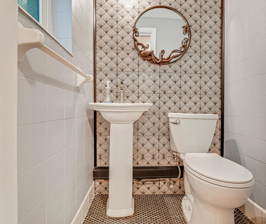 6590 North Ocean Boulevard, Unit 3 Ocean Ridge, FL 33435 - Photo 18 of 48 a bathroom with a toilet and a mirror