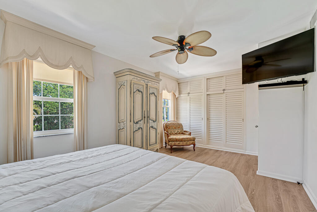 6590 North Ocean Boulevard, Unit 3 Ocean Ridge, FL 33435 - Photo 22 of 48 a bedroom with a bed and a flat screen tv