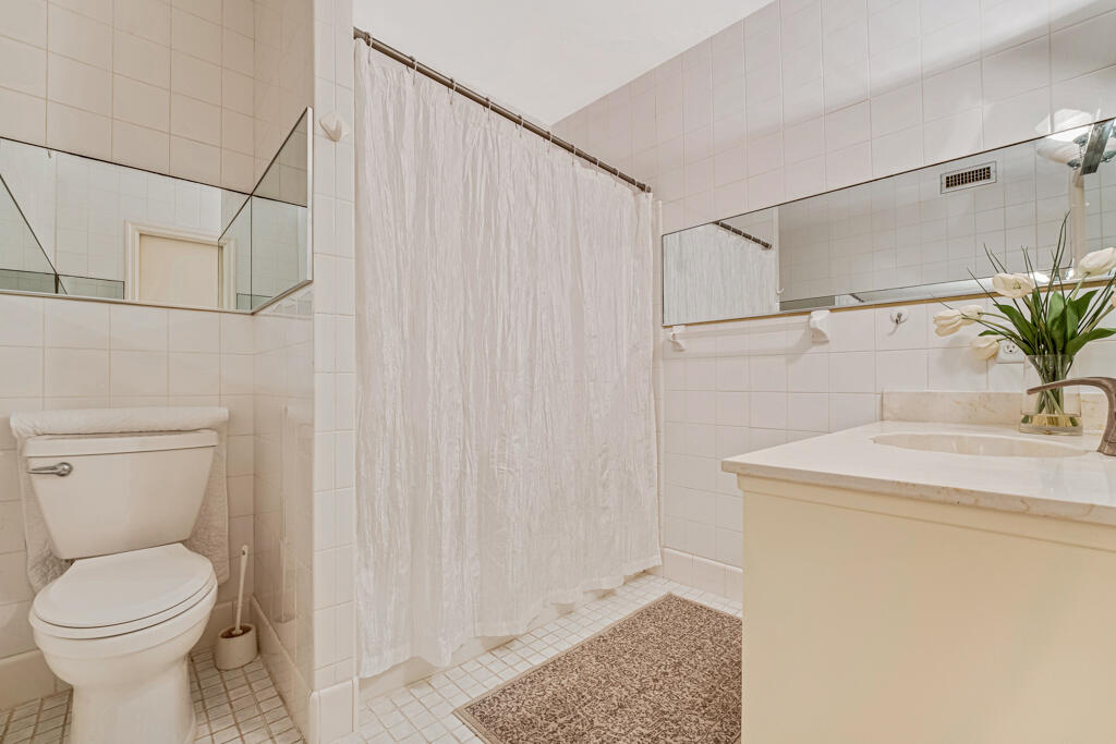 6590 North Ocean Boulevard, Unit 3 Ocean Ridge, FL 33435 - Photo 23 of 48 a bathroom with a sink a toilet and shower