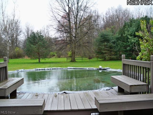 6421 Peck Road Ravenna, OH 44266 - Photo 11 of 15 Views of the above ground pool totally deck around the pool and back of the house around the 3 season room