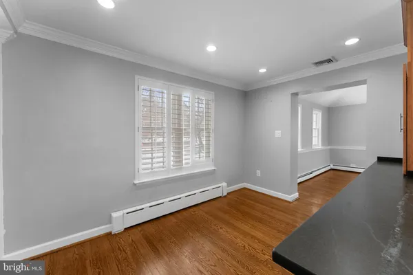 a kitchen with stainless steel appliances granite countertop a refrigerator a stove and a wooden floors