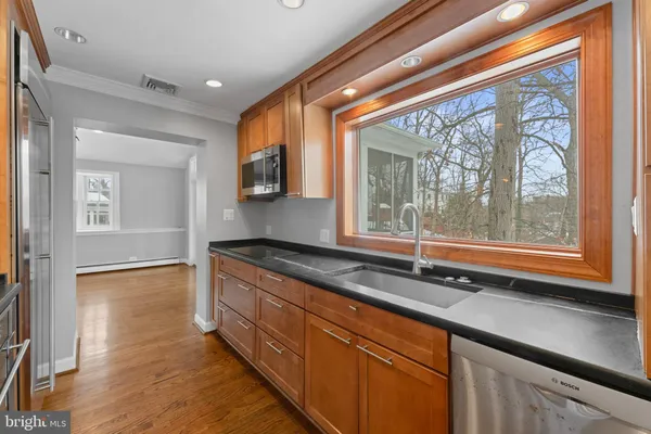 a kitchen with stainless steel appliances granite countertop a stove and a sink