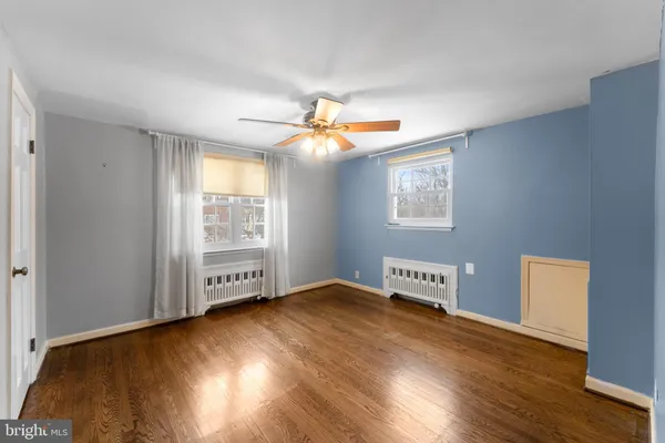 an empty room with wooden floor and a window