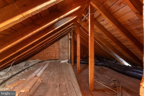 a view of a hallway with wooden floor and entryway