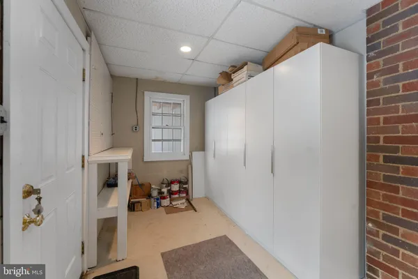 a room with baby crib and dresser