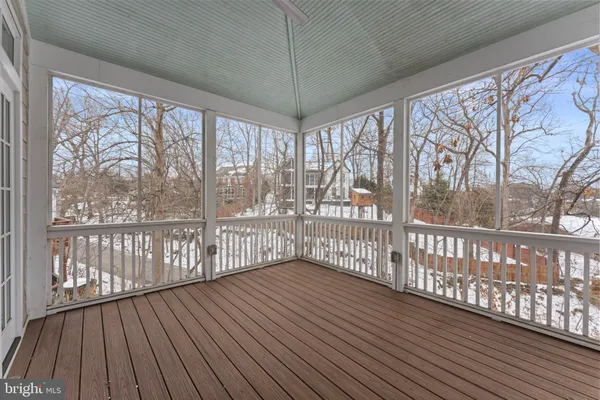 a view of empty room with wooden floor and windows