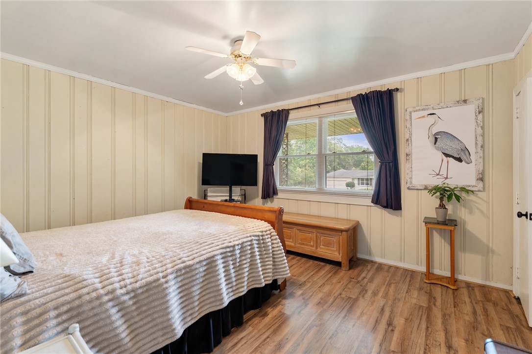 1105 Greenacres Anderson, SC 29621 - Photo 25 of 46 Well-lit sleeping quarters with rich wood-look flooring and a functional ceiling fan.