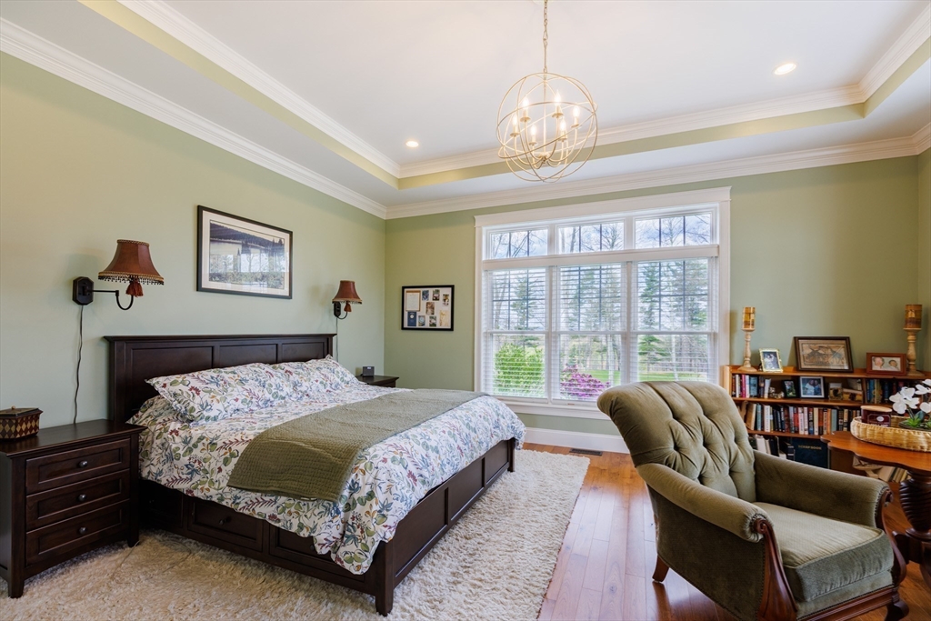 1776 Old Turnpike Road Oakham, MA 01068 - Photo 14 of 42 a bedroom with a bed and a chandelier