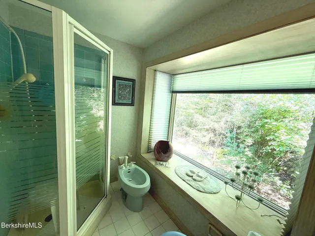 a bathroom with a toilet sink and shower