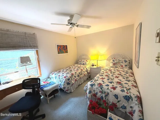 a bedroom with three beds and painted walls