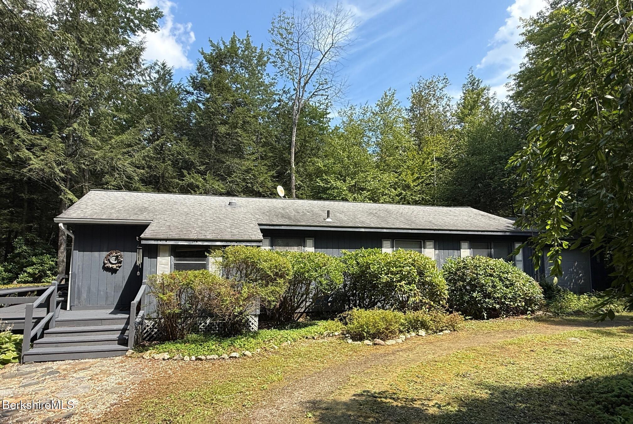 58 Evergreen Road Otis, MA 01029 - Photo 2 of 27 a front view of a house with a yard