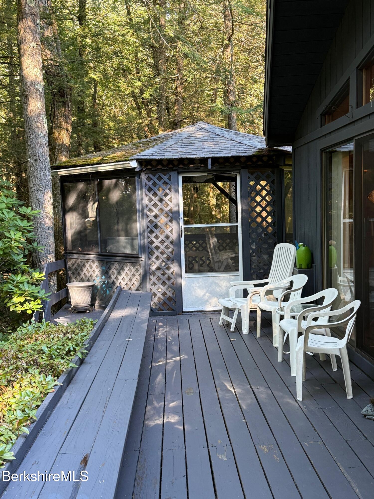 58 Evergreen Road Otis, MA 01029 - Photo 4 of 27 a balcony with wooden floor table and chairs
