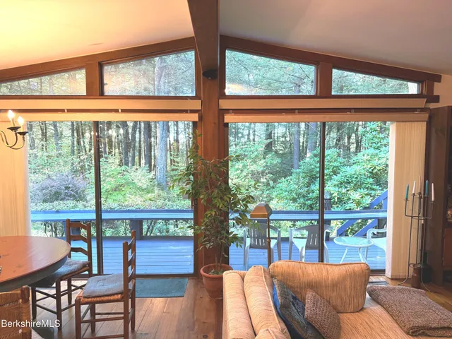 a balcony with furniture and wooden floor